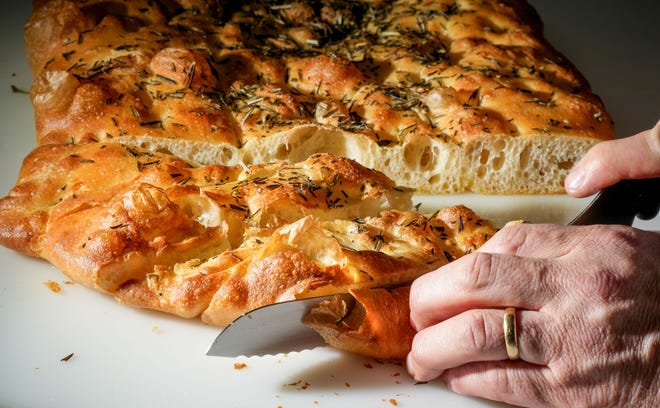 Chef-owner Adam Siegel slices focaccia for the bread baskets at Lupi and Iris restaurant downtown.