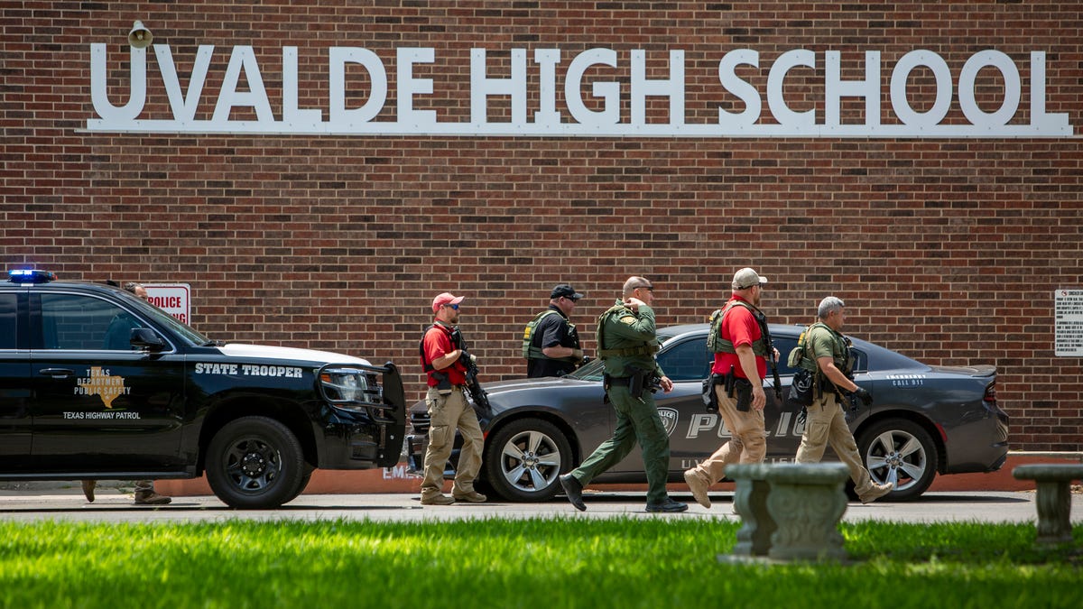 Law enforcement personnel walk outside Uvalde High School after shooting a was reported earlier in the day at Robb Elementary School, Tuesday, May 24, 2022, in Uvalde, Texas. 