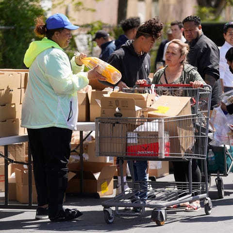 A Utah Food Bank volunteer loads groceries for a w