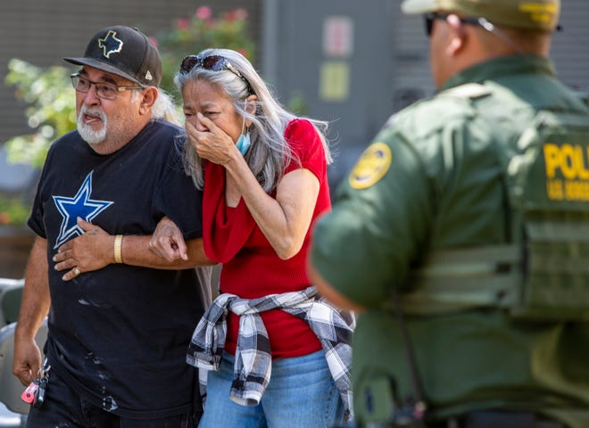 A woman cries as she leaves the Uvalde Civic Center, Tuesday May 24, 2022, in Uvalde, Texas An 18-year-old gunman opened fire Tuesday at a Texas elementary school, killing multiple children and a teacher and wounding others, Gov. Greg Abbott said, and the gunman was dead.