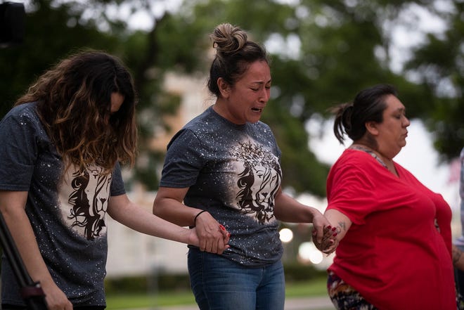Gladys Castillon, middle, joins community members in prayer at the Uvalde downtown plaza following the shooting at Robb Elementary School in Uvalde, Texas on Tuesday, May 24, 2022. The shooting killed 19 children and two adults.