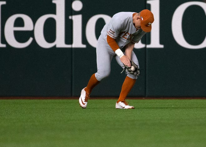 Texas' Eric Kennedy makes a catch during Wednesday night's win over Oklahoma State in the Big 12 Tournament's first round. But on Saturday, the Cowboys avenged the loss with an 8-1 win to force a rematch in the afternoon. The winner will move on to the championship game.