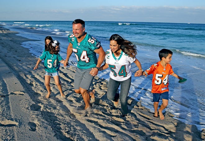 Former Dolphins linebacker Zach Thomas runs on the beach with his wife Maritza and their kids Valentina, Sienna, and Christian, at their home in Hillsborough Beach, Florida, in January 2020.