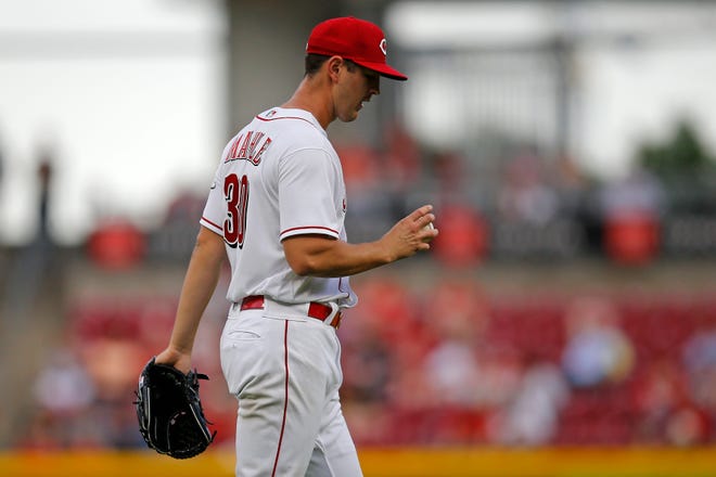 Cincinnati Reds starting pitcher Tyler Mahle (30) collects a new baseball after giving up a two-RBI triple in the third inning of the MLB National League game between the Cincinnati Reds and the Chicago Cubs at Great American Ball Park in downtown Cincinnati on Tuesday, May 24, 2022.