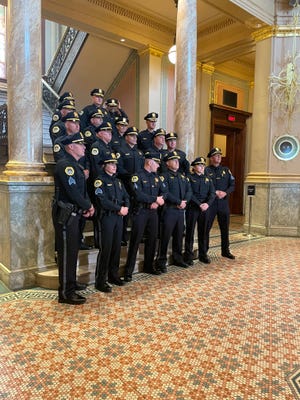 Newly-promoted DMPD sergeants, lieutenants, captains and majors pose on the steps of the World Food Prize building after a ceremony May 25.