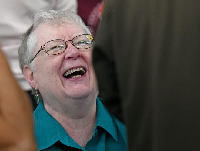 Nancy Collier of Holy Trinity Lutheran Church shares a laugh with visitors Wednesday morning during the Ohio District 5 Area Agency's Senior Spring Extravaganza at the Richland County Fairgrounds.