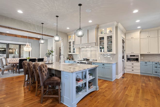 The cook’s-dream kitchen features twin sinks and two dishwashers as well as an island with seating.