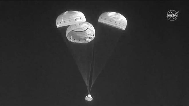 In this infrared image from video made available by NASA, the Boeing Starliner capsule uses parachutes as it descends to land at the White Sands Missile Range in New Mexico on Wednesday, May 25, 2022.