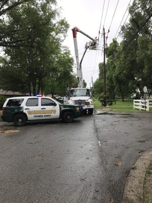 Florida Power & Light crews work to restore electricity in the wake of severe storms in Pensacola on Wednesday.