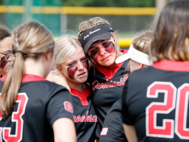Crooksville outfielders Emma Wilson, left, and Gracie Peck console each other following a 7-0 loss to Portsmouth West in a Division III regional semifinal on Wednesday at Unioto High School in Chillicothe. Wilson and Peck had the team's lone hits off West ace Sydney McDermott, who struck out 18 batters in a complete game.