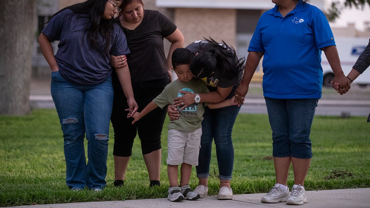 Community members gather in prayer at a downtown plaza after the shooting at Robb Elementary School in Uvalde, Texas, on May 24. The shooting killed 19 children and two adults.