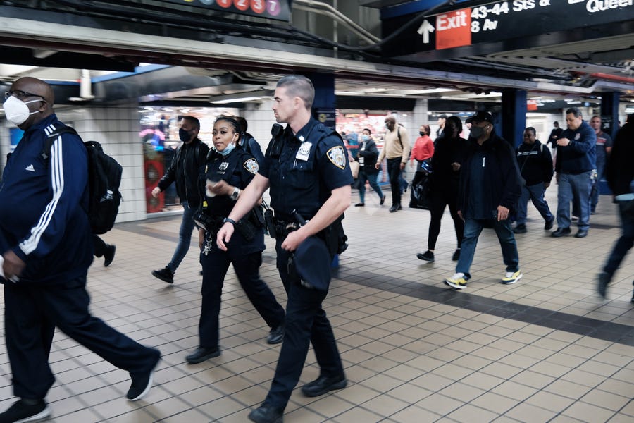 Police walk through a Manhattan subway station on May 24, 2022 in New York City. As the city tries to get back to its pre-pandemic commuter levels, it has experienced a surge in subway crime.