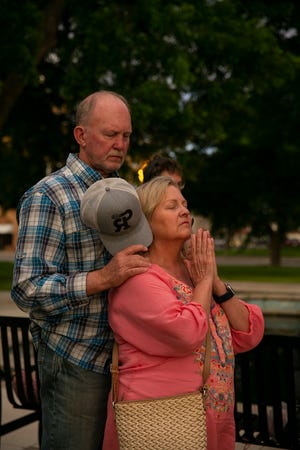 Billy and Lisa Wagner pray at the Uvalde downtown plaza following the shooting at Robb Elementary School in Uvalde, Texas on Tuesday, May 24, 2022. The shooting killed 19 children and two adults. 