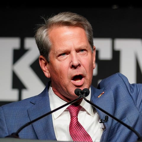 Republican Gov. Brian Kemp waves to supporters dur