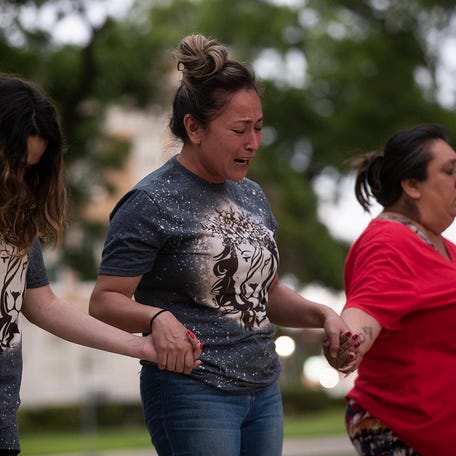 Gladys Castillon, middle, joins community members in prayer at the downtown plaza after the shooting at Robb Elementary School in Uvalde, Texas, on May 24 killed 19 children and two adults.