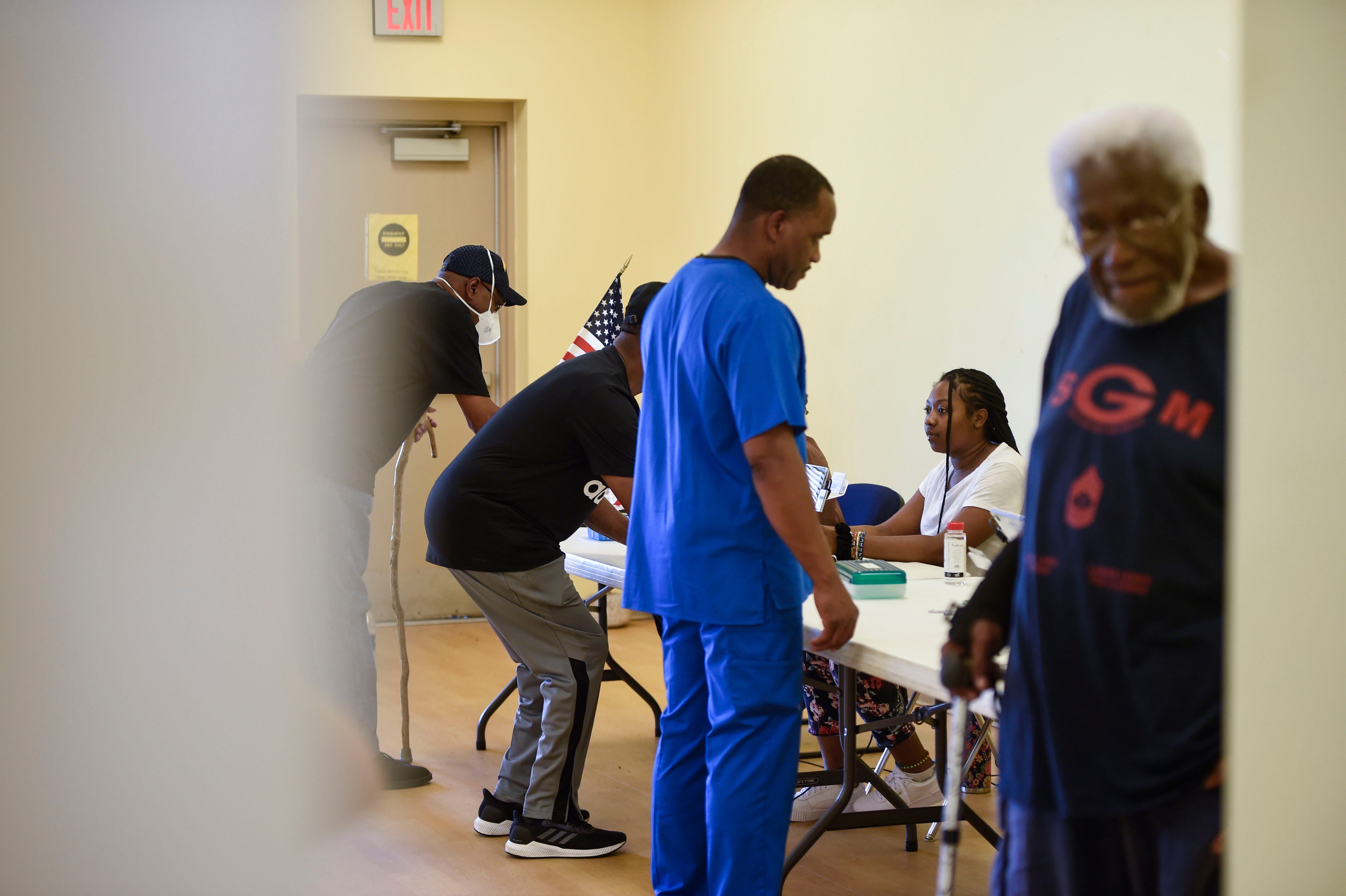 Poll workers check in voters May 24 at the Robert Howard Community Center at Diamond Lakes Regional Park in Georgia.