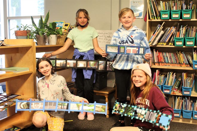 A group of Black River Elementary students display their completed alphabet photography pieces.