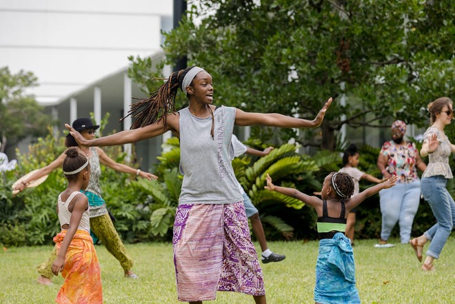 Children and adults take part in a recent Juneteenth celebration at the Norton Museum of Art.