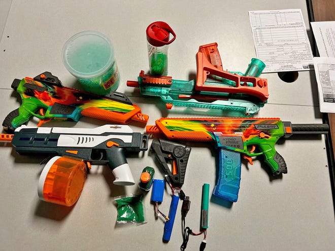 This photo, provided by the Hagerstown Police Department in Maryland, shows pellet guns, gel beads and other items that were confiscated from a car suspected in drive-by shootings involving the toys. At least one person was charged with assault in that case.