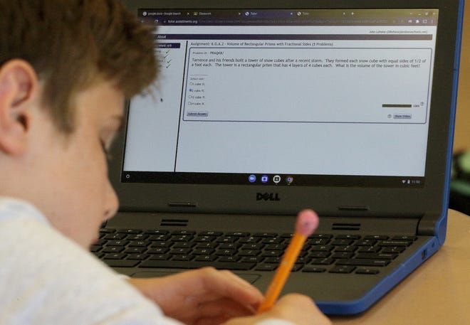 Jack Lehane, 12, uses ASSISTments in working on homework during one of Palmina Griffin's sixth grade math classes at the P. Brent Trottier Middle School in Southborough, May 26, 2022. The class was working on calculating volumes.