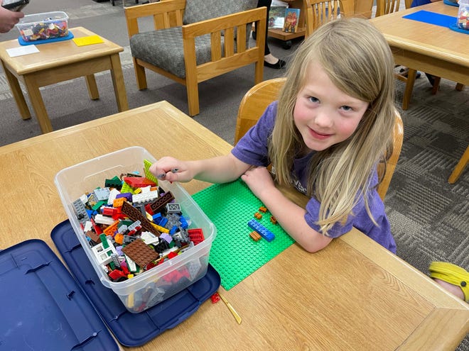Lydia Jerviss, 6, has a build underway, but she said she's not quite sure what it is yet at the monthly LEGO Club at Karns Branch Library Saturday, May 21, 2022.