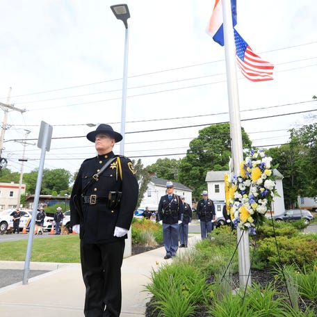 Deputies from the Dutchess County Sheriff's Office stand for the playing of Taps after laying memorial wreaths during Thursday's Memorial Day ceremony on May 26, 2022. 