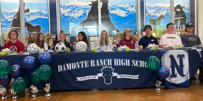 Damonte Ranch's nine future college athletes smile after the school's signing ceremony on Wednesday.