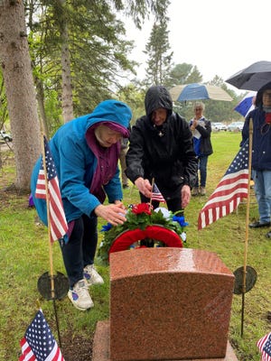 Daughters of the American Revolution members Carol Berens and Jane Johnson set up a wreath on May 25 at the grave of the unknown soldier in Pine Grove Cemetery in Wausau.