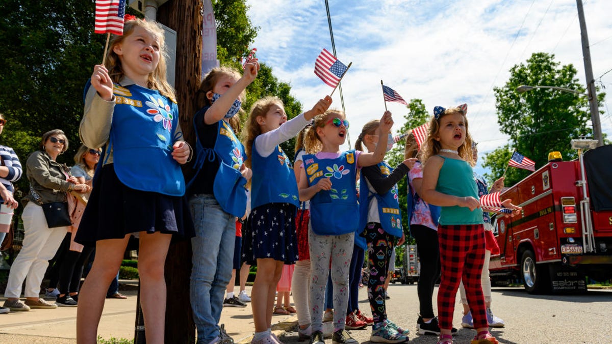 OAKMONT, PA - MAY 31: Girl Scouts in Troop 52368 wait for candy and watch parade marchers during the 2021 Oakmont-Verona Memorial Day Parade on May 31, 2021 in Oakmont, Pennsylvania.  (Photo by Jeff Swensen/Getty Images)