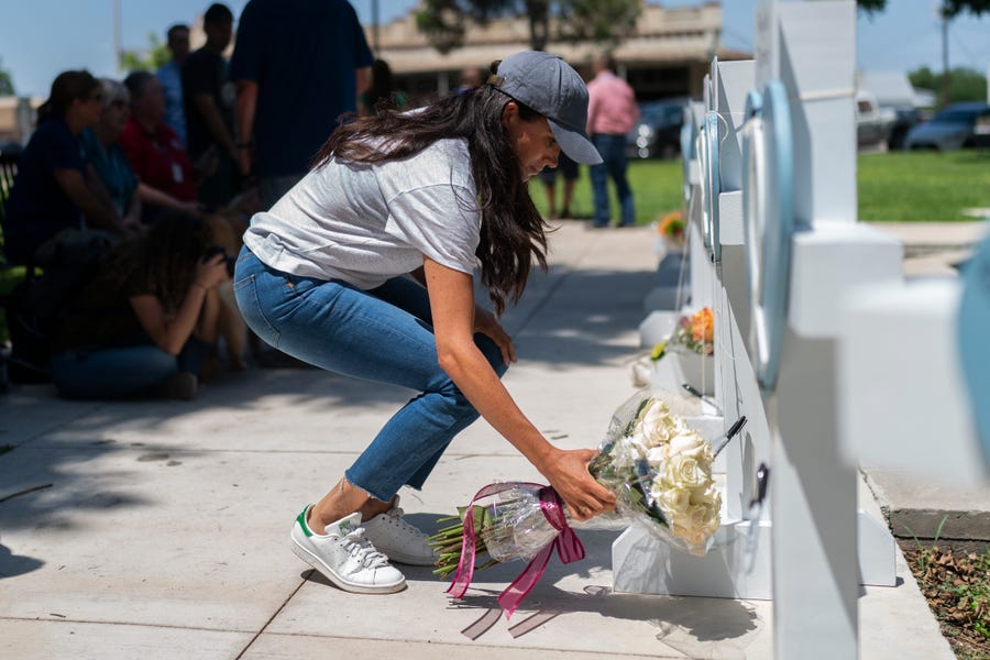 Meghan Markle, Duchess of Sussex, leaves flowers at a memorial site on May 26, 2022, for the victims killed in an elementary school shooting in Uvalde, Texas on May 24, 2022.