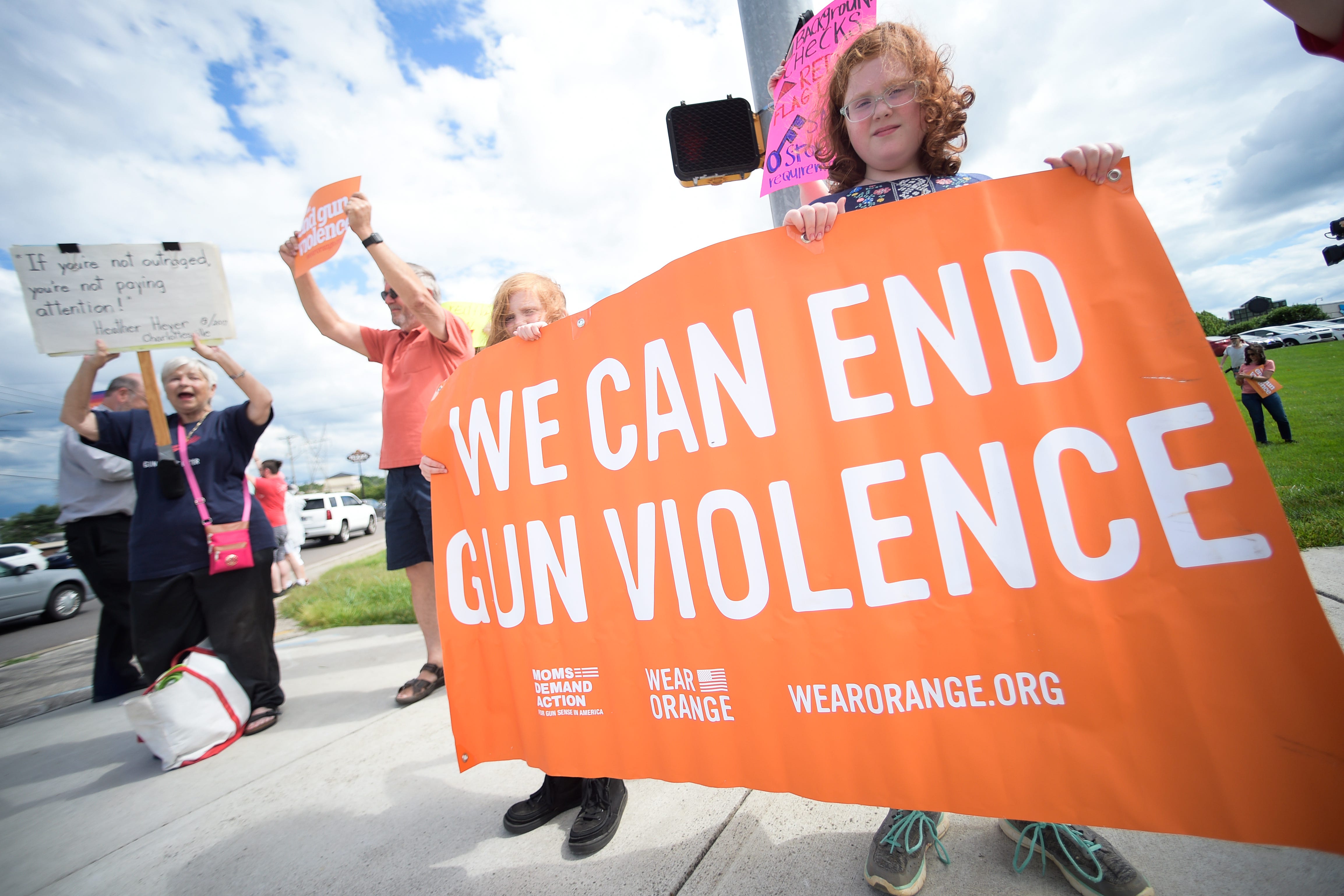 Demonstrators hold a sign reading "We Can End Gun Violence" at a demonstration against gun violence on the corner of Kingston Pike and Morrell Road in Knoxville on May 27, 2022. Demonstrators from Moms Demand Action and members of the community rallied to speak out against gun violence following the Uvalde, Texas, school shooting.