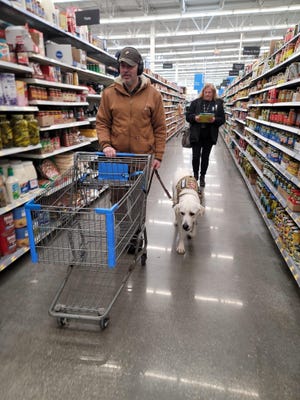 Jesse Lovell goes shopping with his service dog, Oliver, and Dogs 2 Dog Tags executive director Pam Wittkopp.