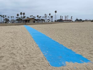 A bright blue mat recently installed at Ventura's Harbor Cove Beach will allow some visitors to get closer to the water's edge.