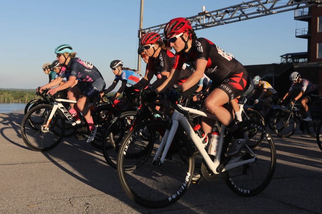Riders take off at the start of the Friday Night Fever Criterium Women's Cat 1,2 and Pro race, a brand new event that replaces the previous Burlington Road Race Friday May 27, 2022 in Burlington.  Friday Night Fever Criterium is a 14 block, 1,024 mile loop course.