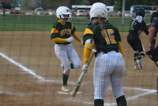 CMR's Tori Lapierre (16) watches as Sarah Faulk crosses the plate with another run for the Lady Rustlers in their loser out win over the Glacier Wolfpack Friday at the Class AA State Tournament in Missoula. The Rustlers finished fourth after being ousted by Helena Capital in the next game, 6-3.