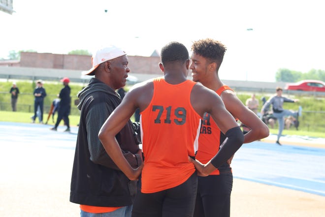 Mansfield Senior's track coach Tyree Shine talks with high jumpers Maurice Ware and Amil Upchurch during the Division I Regional track meet in Findlay.