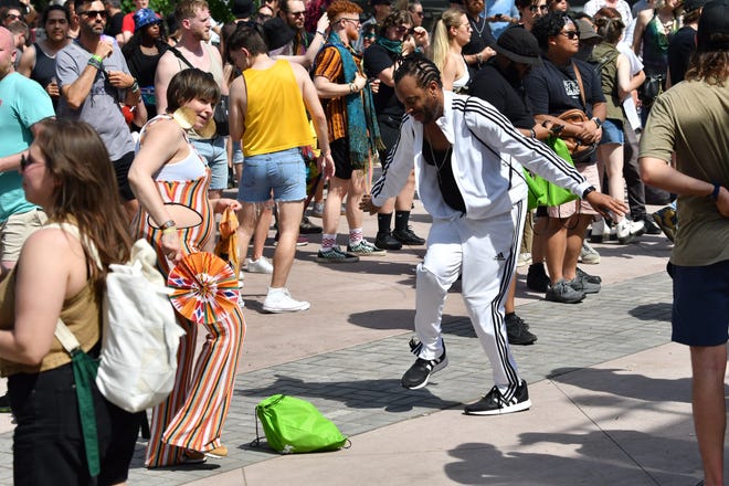 Kelly Gorz, left, of Chicago and Ismail Walton dance at the Stargate Stage to the music spun by Stacey Hotwaxx Hale at the 2022 Movement Electronic Music Festival at Hart Plaza in Detroit on Sunday, May 29, 2022.