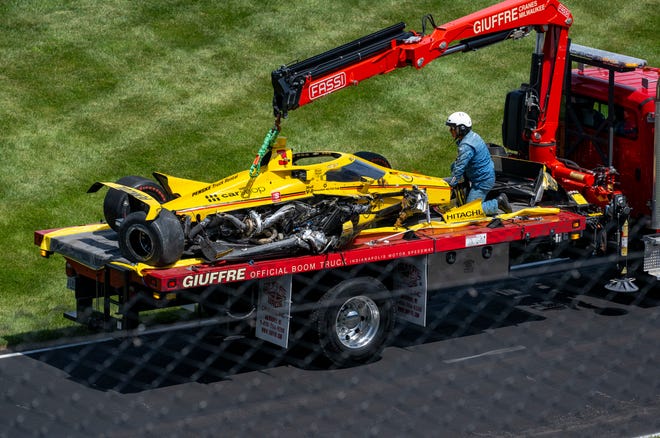 The heavily-damaged car of Team Penske driver Scott McLaughlin (3) is taken from the track after a turn in the fourth turn during the 106th running of the Indianapolis 500, Sunday, May 29, 2022, at The Indianapolis Motor Speedway.