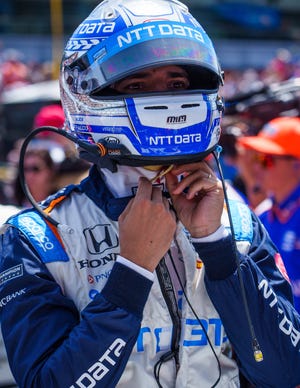 Chip Ganassi Racing driver Álex Palou (10) puts on his helmet Sunday, May 29, 2022, prior to the start of the 106th running of the Indianapolis 500 at Indianapolis Motor Speedway. 
