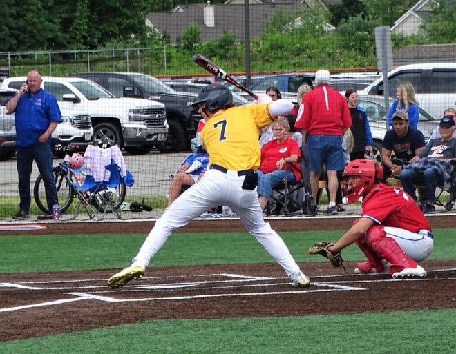 Lancaster's Tony Falvo prepares to hit the ball with Grove City catcher Grady Speegle behind the plate during their Division I Central District final.  The Greyhounds won, 2-0, in eight innings.