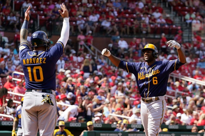 Brewers centerfielder Lorenzo Cain is greeted by Omar Narvaez after hitting a two-run home run, his first longball of the season, during the eighth inning against the Cardinals on Sunday.