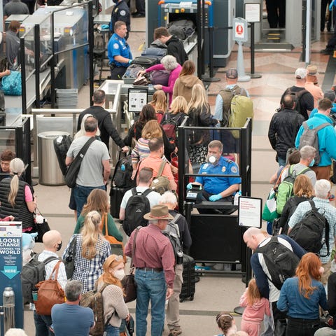Travelers queue up move through the north security