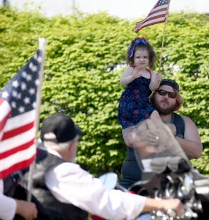 Aubree Croston, 2, watches the Canton Memorial Day Parade on Monday from the shoulder of her father, Cory Croston of Canton.