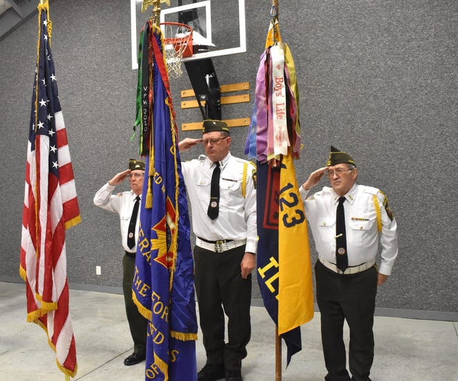 Orion Veterans of Foreign Wars Post 143 sponsors Orion Cub Scout Pack 123. The VFW furnished a color guard for the Blue and Gold banquet on Sunday, May 1, in the Methodist Activity Center. From left are Darrel Muhleman, Kyle Noard and Dick Gustafson.