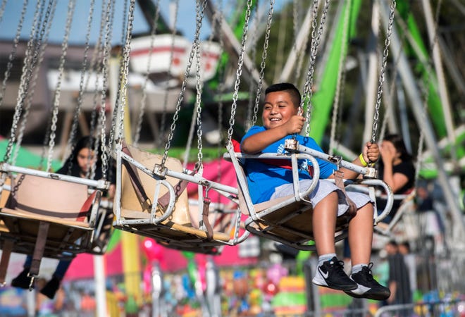 Nine-year-old Abel Tecupa of Stockton rides the Phoenix on opening day of the San Joaquin County Fair at the San Joaquin County Fairgrounds in Stockton.