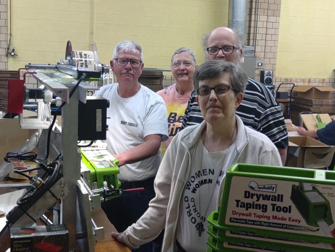 Buddy Tools are packaged at Waycraft Inc. in Bucyrus. Pictured are, left to right, Ron Morton, Direct Support Professional Supervisor Kathy Stinchcomb, and Jeff and Lisa - two of the workers involved in the packaging.