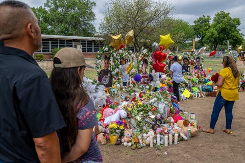 People visit a memorial dedicated to the 19 children and two adults killed on May 24 during the mass shooting at Robb Elementary School on May 31, 2022, in Uvalde, Texas. Opening wakes and funerals for the 21 victims will be scheduled throughout the week.