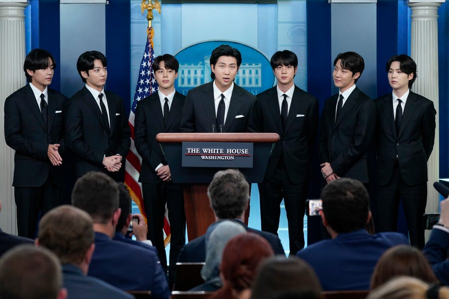 Members of the K-pop supergroup BTS join White House press secretary Karine Jean-Pierre during the daily briefing at the White House on May 31 in Washington.