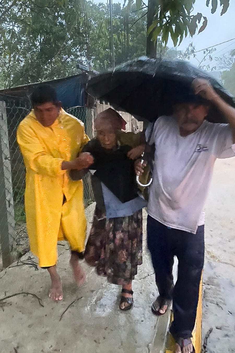 People try to take cover from the rain during the arrival of Hurricane Agatha in Huatulco, Oaxaca State, Mexico on May 30, 2022.