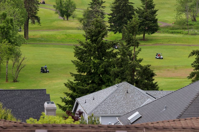 Houses are seen as golfers play golf at Creekside Golf Club in Salem, Ore. on Wednesday, June 1, 2022.